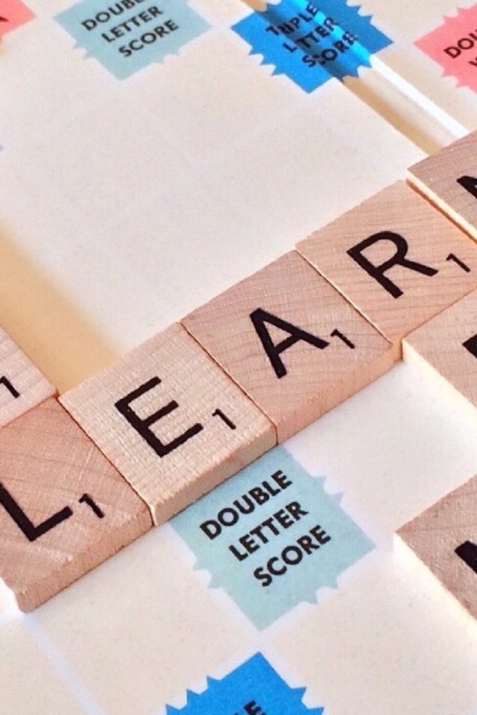 Close-up of Scrabble tiles forming words related to education and school.